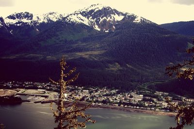 Scenic view of lake by mountains against sky