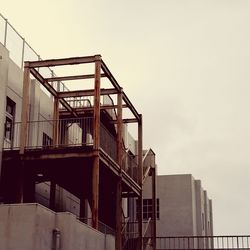Low angle view of staircase by building against clear sky