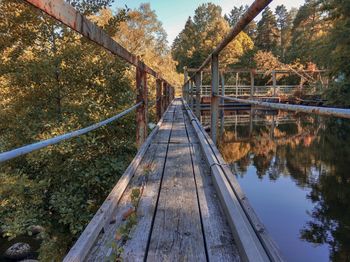 Wooden footbridge over river in forest