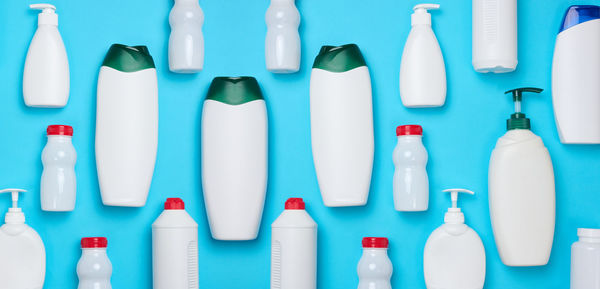 Empty plastic white bottles for cosmetics and other liquid substances on a blue background. blank 