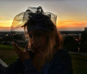 Woman adjusting the netting of her hat