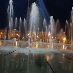 Illuminated fountain at night