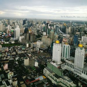 High angle view of modern buildings in city against sky