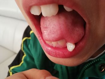 Close-up of boy with tattoo in mouth