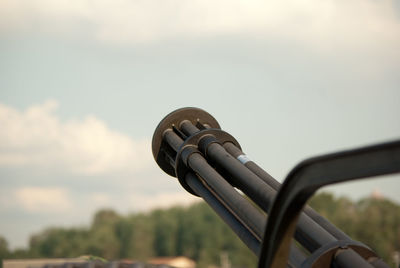 Close-up of coin-operated binoculars against sky