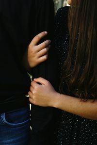 Midsection of couple standing outdoors