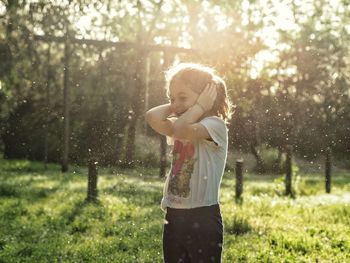 Playful girl standing on field