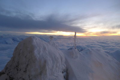 Scenic view of snowcapped mountains against sky during sunset