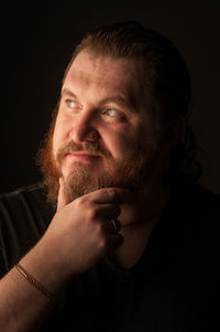 Portrait of man against black background