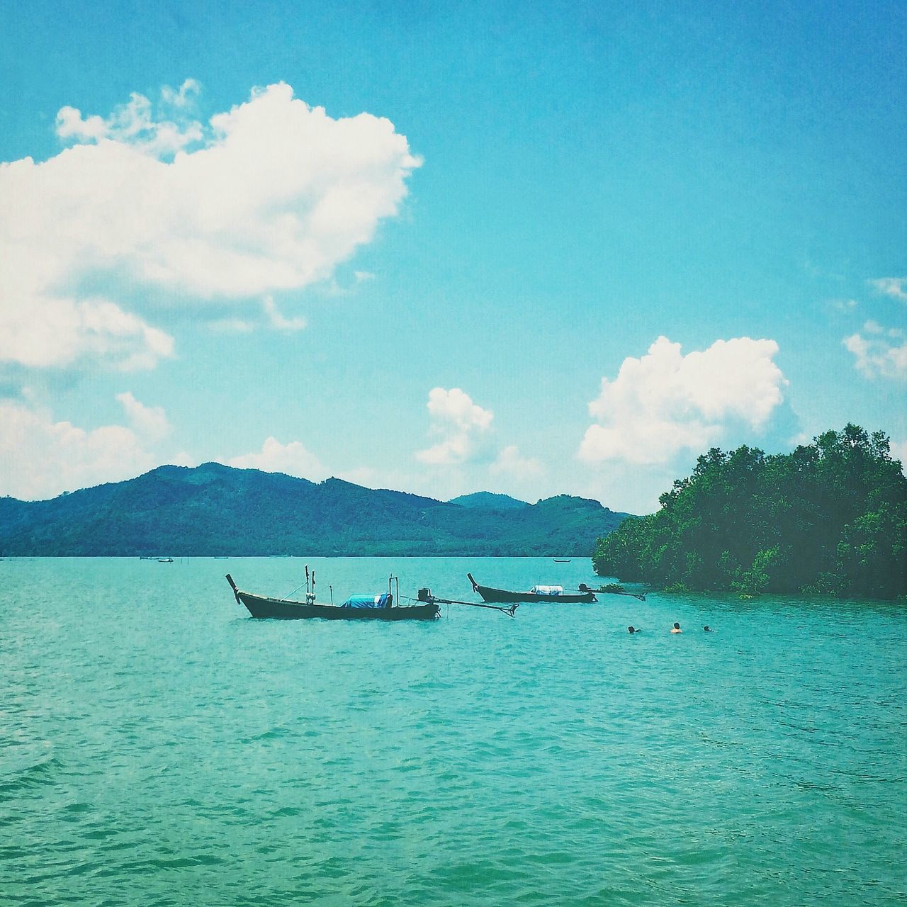 water, nautical vessel, transportation, sky, boat, tranquil scene, waterfront, mountain, tranquility, blue, mode of transport, scenics, beauty in nature, sea, nature, cloud - sky, rippled, cloud, mountain range, day