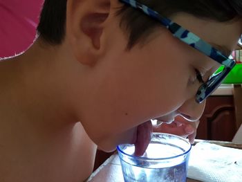 Close-up portrait of boy drinking glass