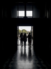 Rear view of men walking on footpath