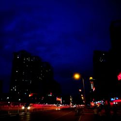 Illuminated city street at night