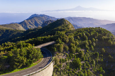 High angle view of road amidst trees against sky