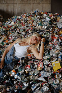 High angle view of woman lying down on garbage