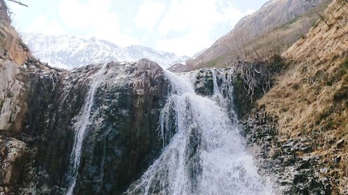 Panoramic view of waterfall against sky