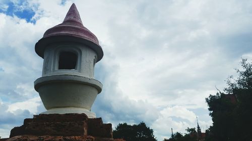 Low angle view of tower against cloudy sky