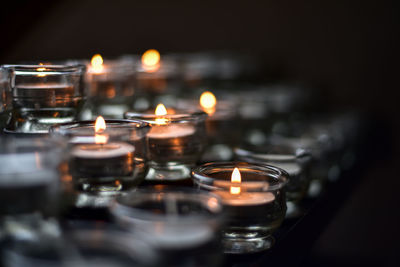 Close-up of tea light candles in temple
