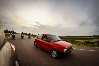 Vintage car on road against sky