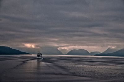 Scenic view of mountains against cloudy sky