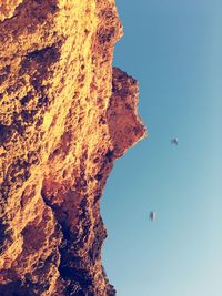Low angle view of rock formation against sky