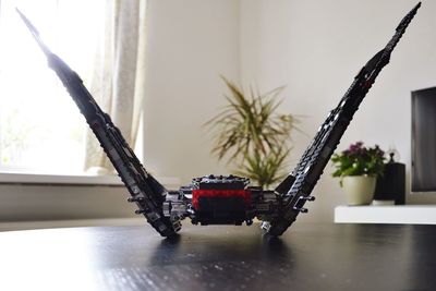 Close-up of toy car on table by window