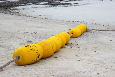 High angle view of yellow toy on beach