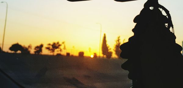 Silhouette person against sky during sunset