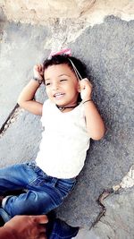 Portrait of smiling girl sitting outdoors