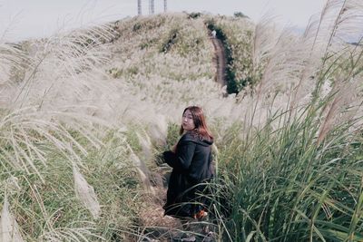 Man sitting on grass in field