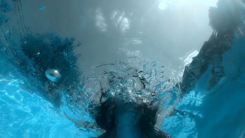 Low angle view of woman swimming in pool