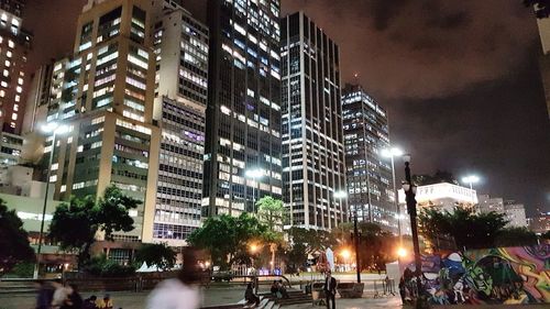 Illuminated city against sky at night