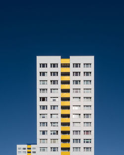 Low angle view of building against clear blue sky