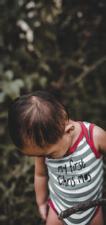 Cute baby boy standing outdoors