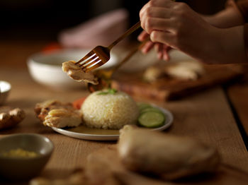 Midsection of person preparing food on table