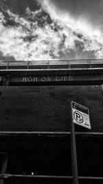 Low angle view of road sign against sky