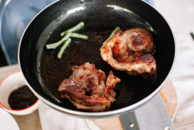 High angle view of meat in cooking pan