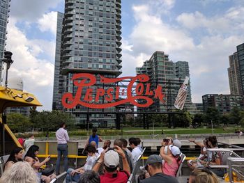 Group of people in front of buildings against sky