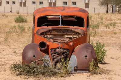 Abandoned car on field