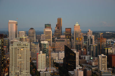 High angle view of skyscrapers in city during sunset