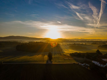 Scenic view of landscape against sky during sunrise