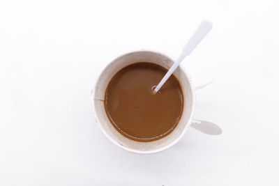 High angle view of coffee cup against white background