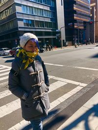 Close-up of woman wearing warm clothes while crossing road