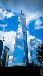 Low angle view of buildings against cloudy sky