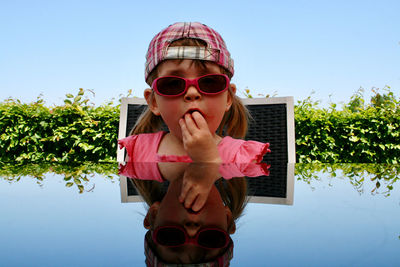 Portrait of boy wearing sunglasses against sky