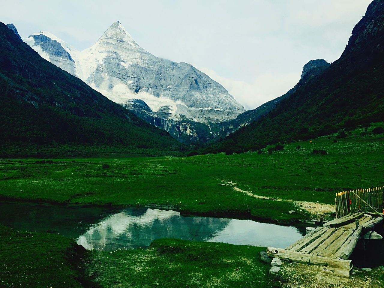 mountain, mountain range, scenics, beauty in nature, tranquil scene, tranquility, snowcapped mountain, landscape, winter, snow, nature, water, non-urban scene, grass, sky, cold temperature, idyllic, green color, lake, season