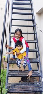 Portrait of mother and son on staircase