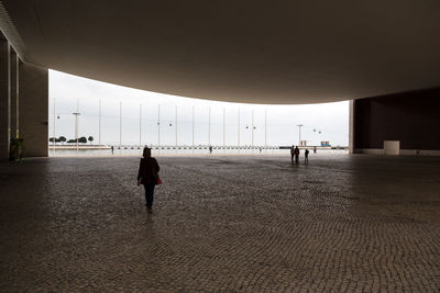 Rear view of man walking in corridor