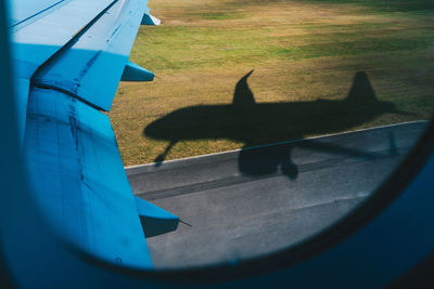 Shadow of a bird on a cropped airplane