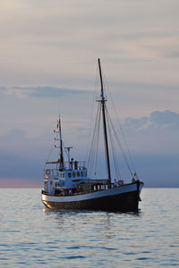 Ship sailing on sea against sky